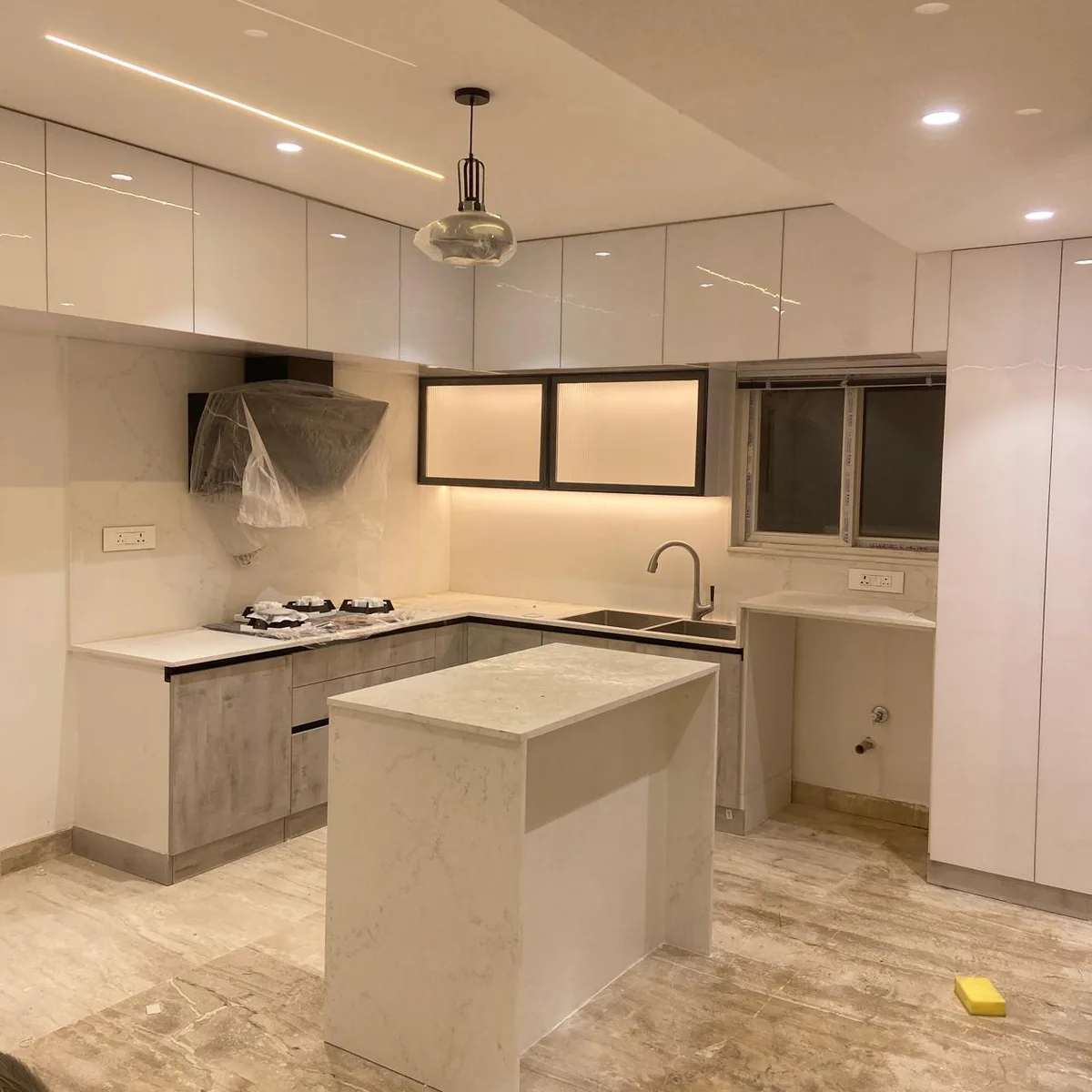 Aditya Empress apartment interiors in Hyderabad by AlcorOne Solutions — Island modular kitchen