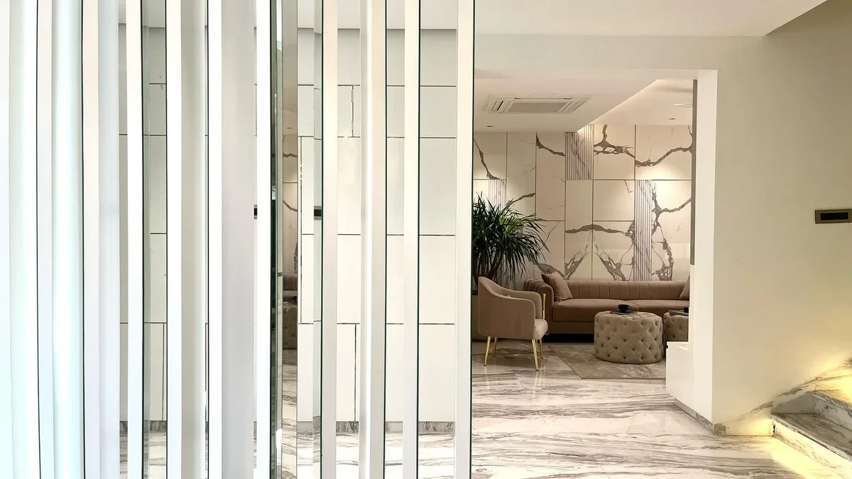 Serene 3BHK Residence interior in Hyderabad by AlcorOne Solutions — Fluted partition to the living room